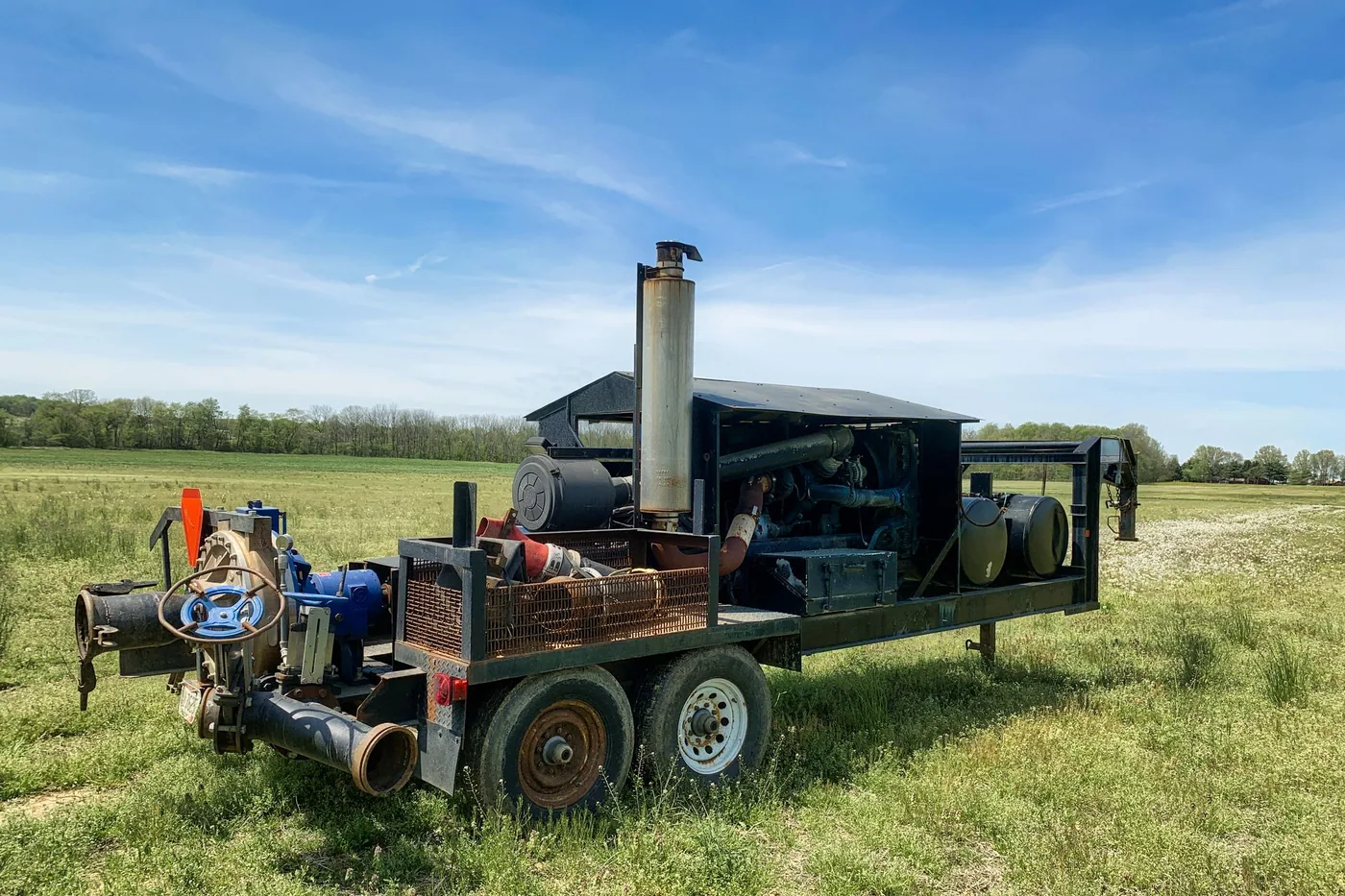 Pumps and valves connected to a run of piping in a water distribution installation.