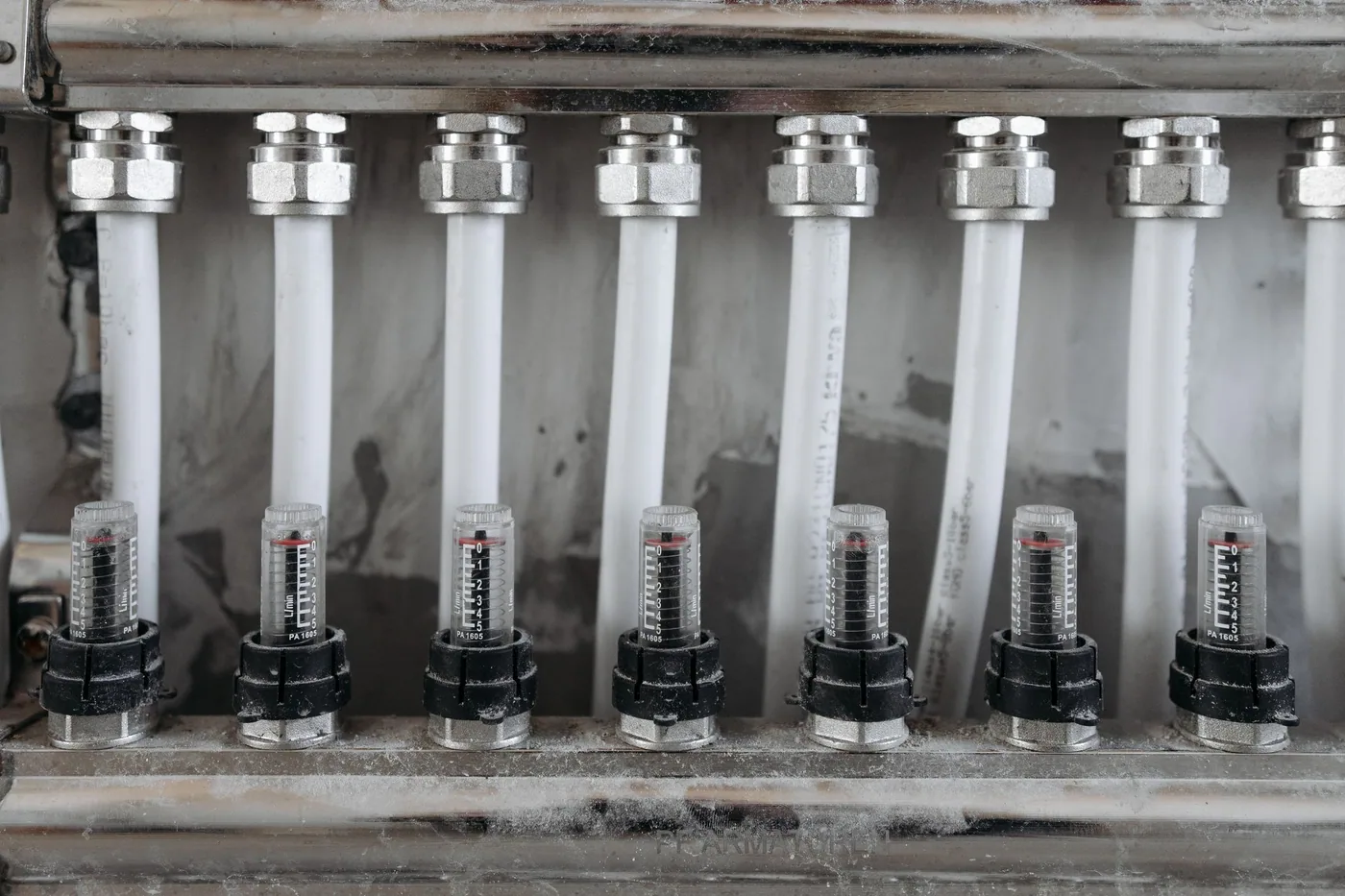 Shelving bays holding sorted plumbing fittings and small metal components in a merchant's store.